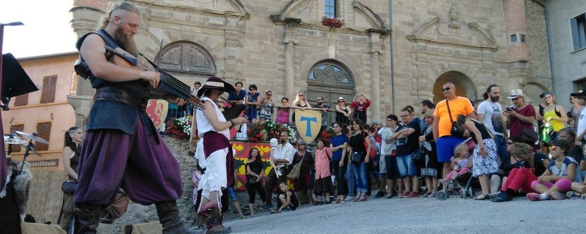 Artistes devant du public pendant les médiévales à Saint-Antoine-l'Abbaye dans l'Isère